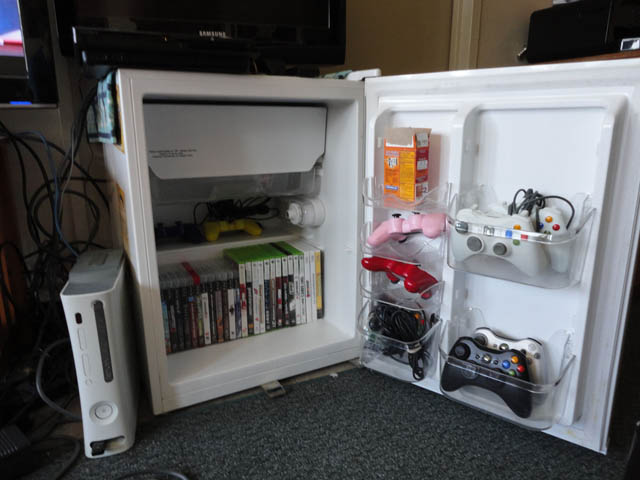 using old mini fridge as tv stand and storage unit